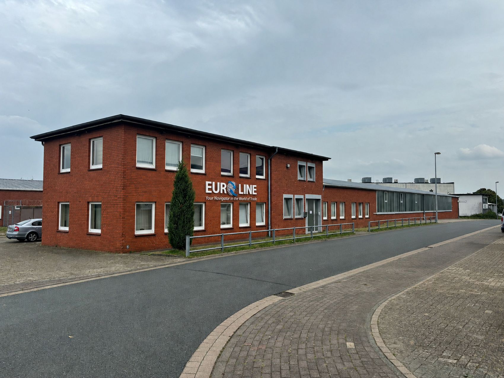 The Euroline GmbH premises at Werkstrasse 4 in Syke — a two-storey brick office block carrying the Euroline sign, with the warehouse running back from it.